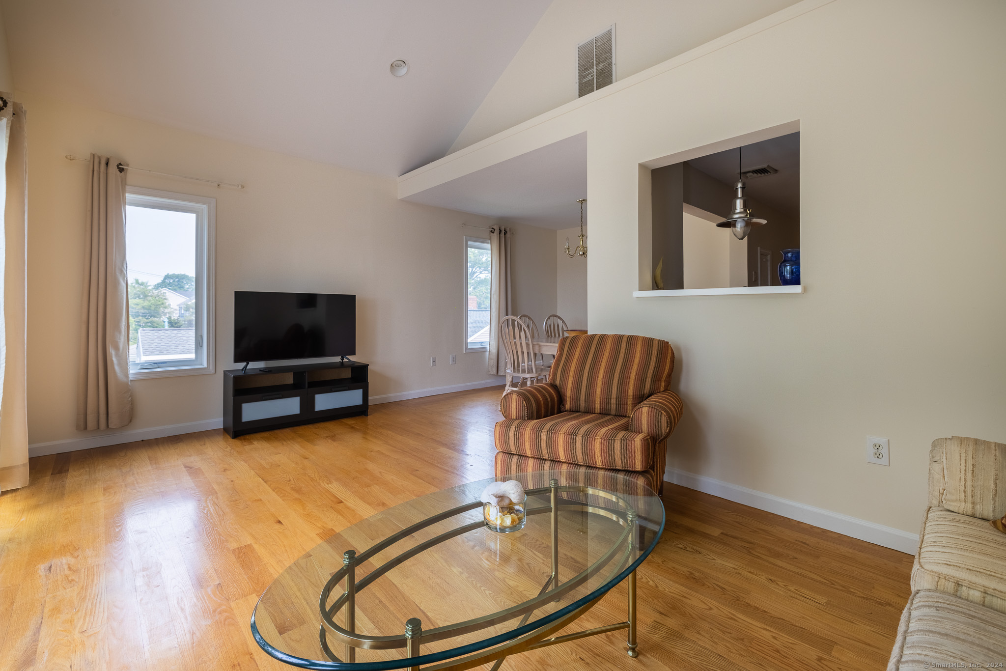 916 Reef Road Fairfield, CT 06824 - Photo 4 of 16 a living room with furniture and a flat screen tv