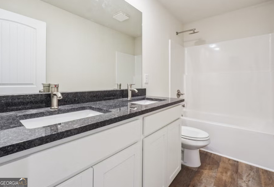 107 Garden Walk West Point, GA 31833 - Photo 6 of 9 a bathroom with a granite countertop sink toilet and shower