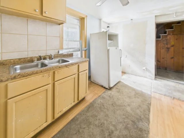 a kitchen with a sink cabinets and refrigerator