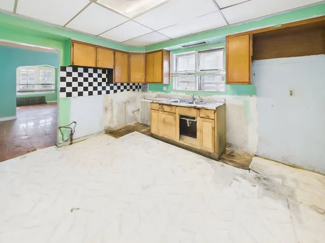 a kitchen with a stove a sink and a microwave