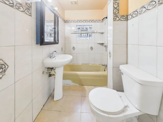 a bathroom with a toilet sink and shower