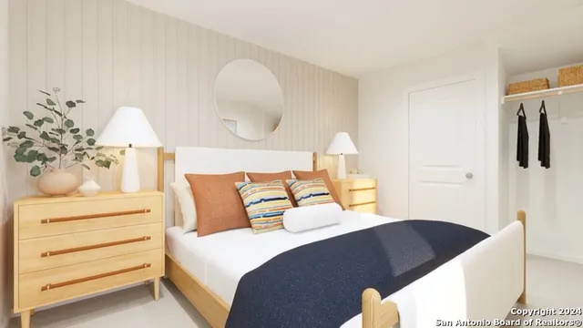 a bedroom with a bed and a lamp