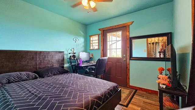 a bedroom with a bed window and dresser