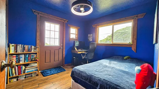 a bedroom with a bed and a book shelf