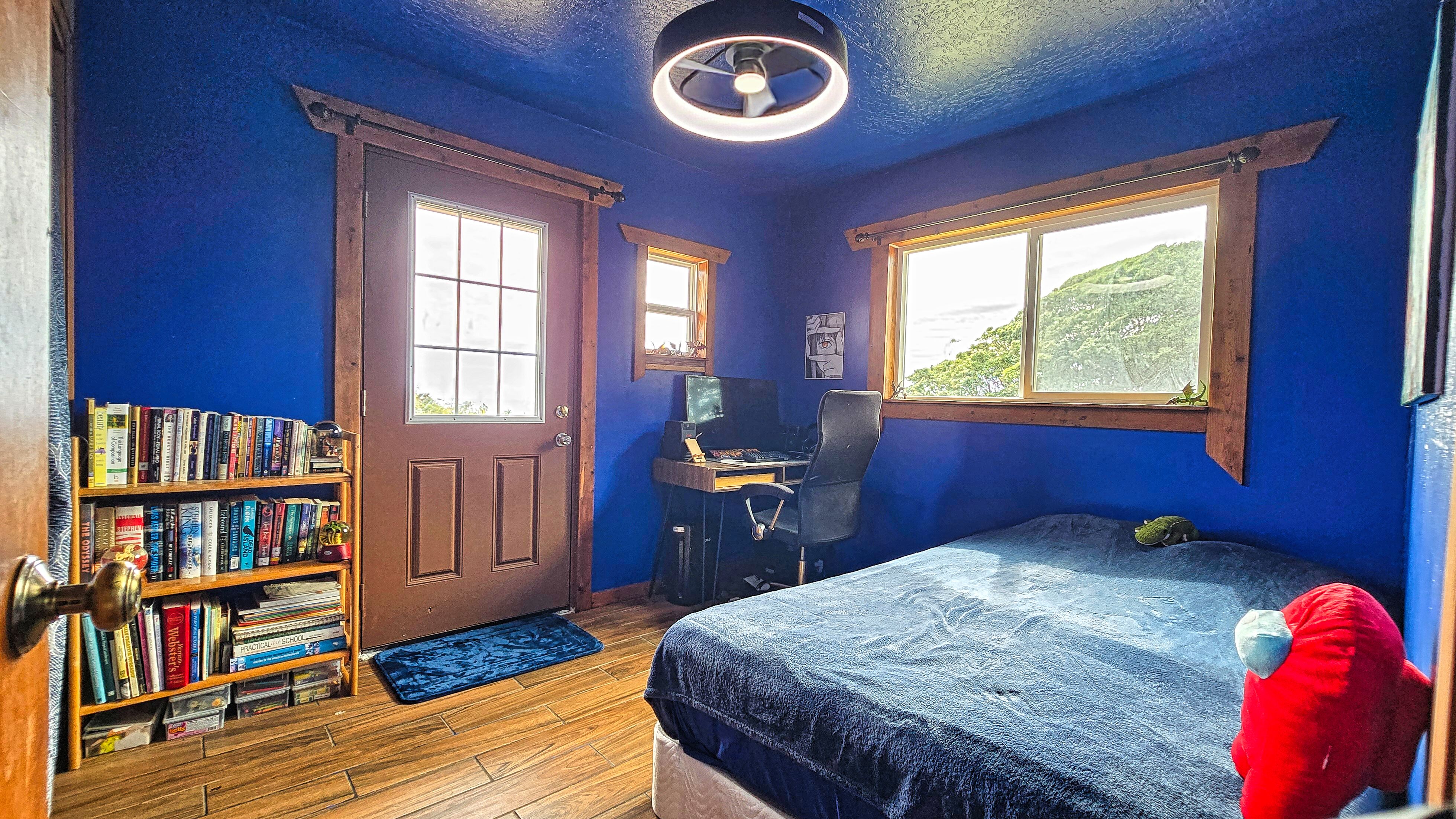 94-6491 Kamaoa Road Naalehu, HI 96772 - Photo 12 of 30 a bedroom with a bed and a book shelf