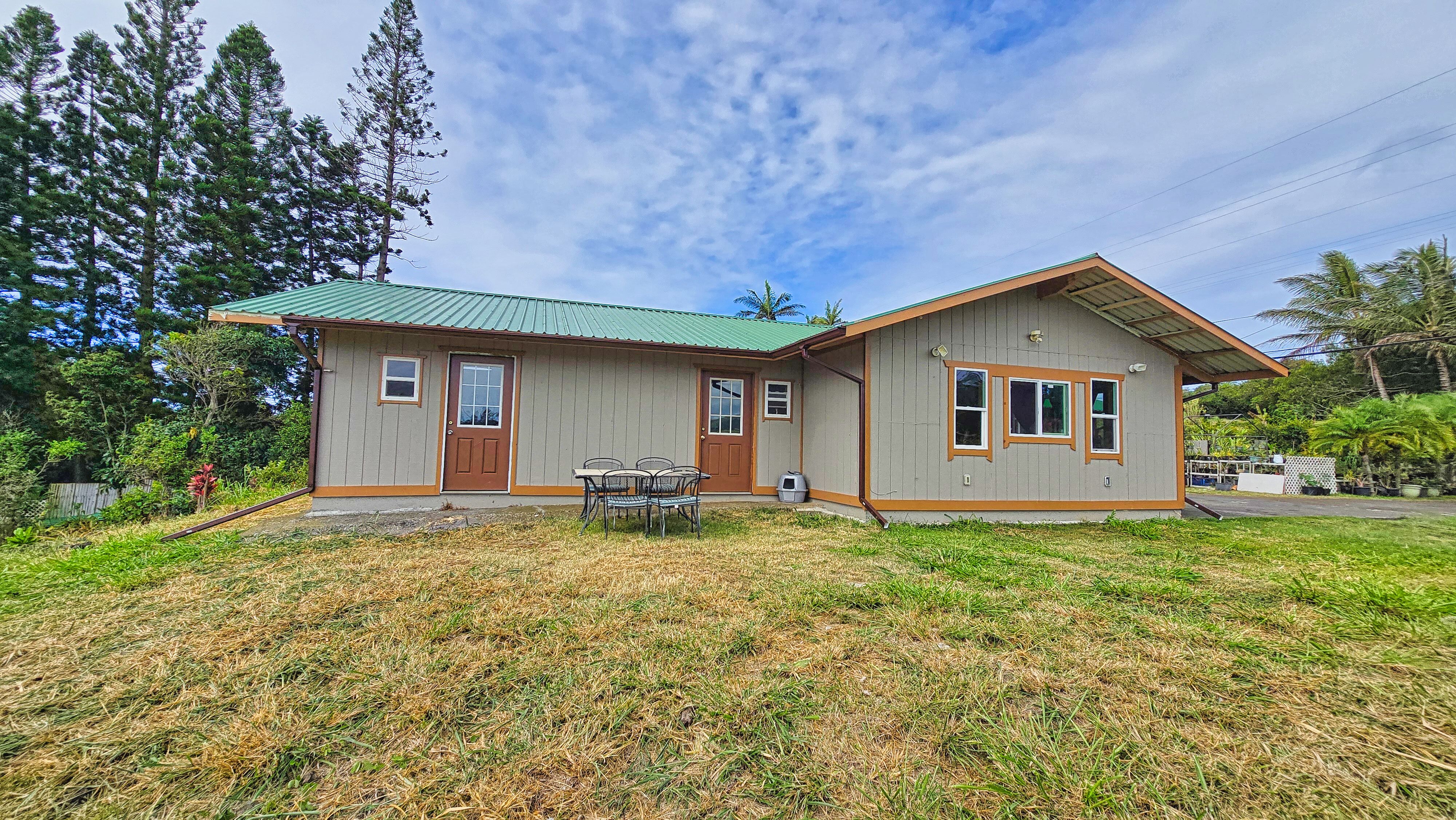 94-6491 Kamaoa Road Naalehu, HI 96772 - Photo 21 of 30 a house with trees in the background