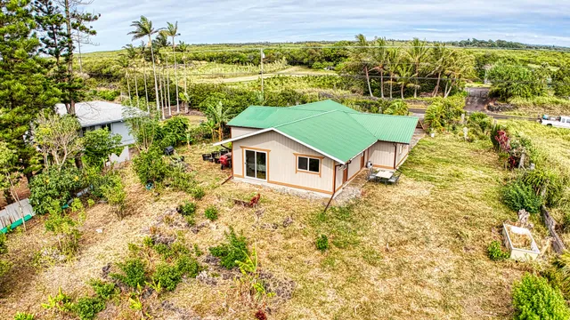 a aerial view of a house with a yard and lake view