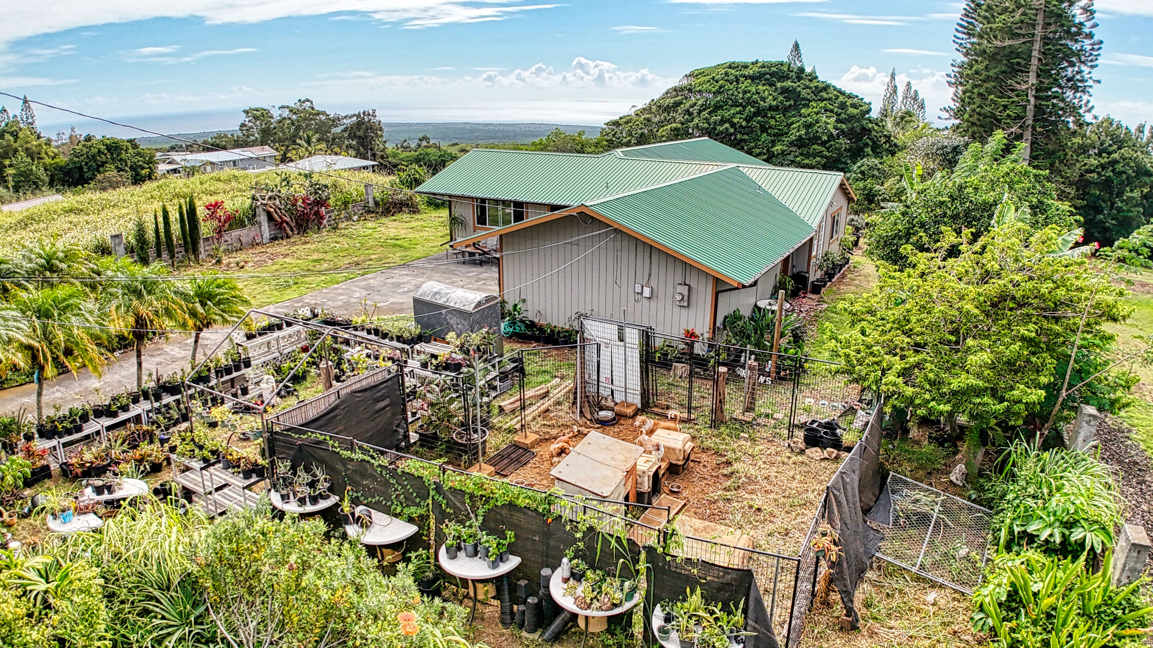 94-6491 Kamaoa Road Naalehu, HI 96772 - Photo 30 of 30 an aerial view of a house with yard swimming pool and outdoor seating