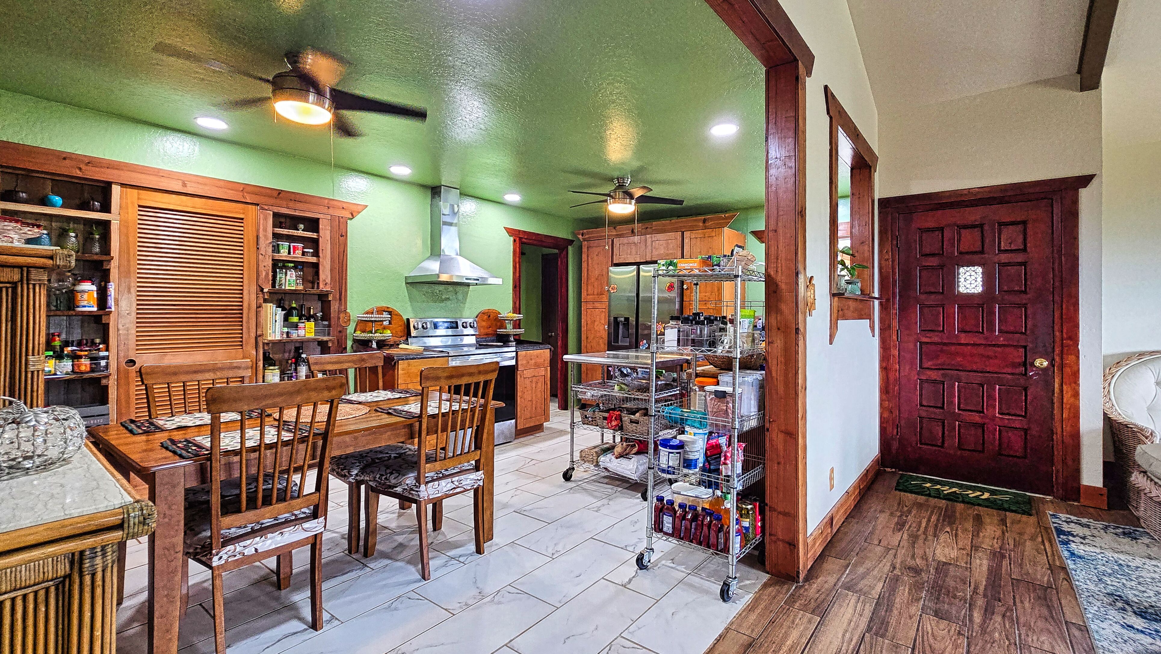 94-6491 Kamaoa Road Naalehu, HI 96772 - Photo 6 of 30 a view of a dining room with furniture and chandelier