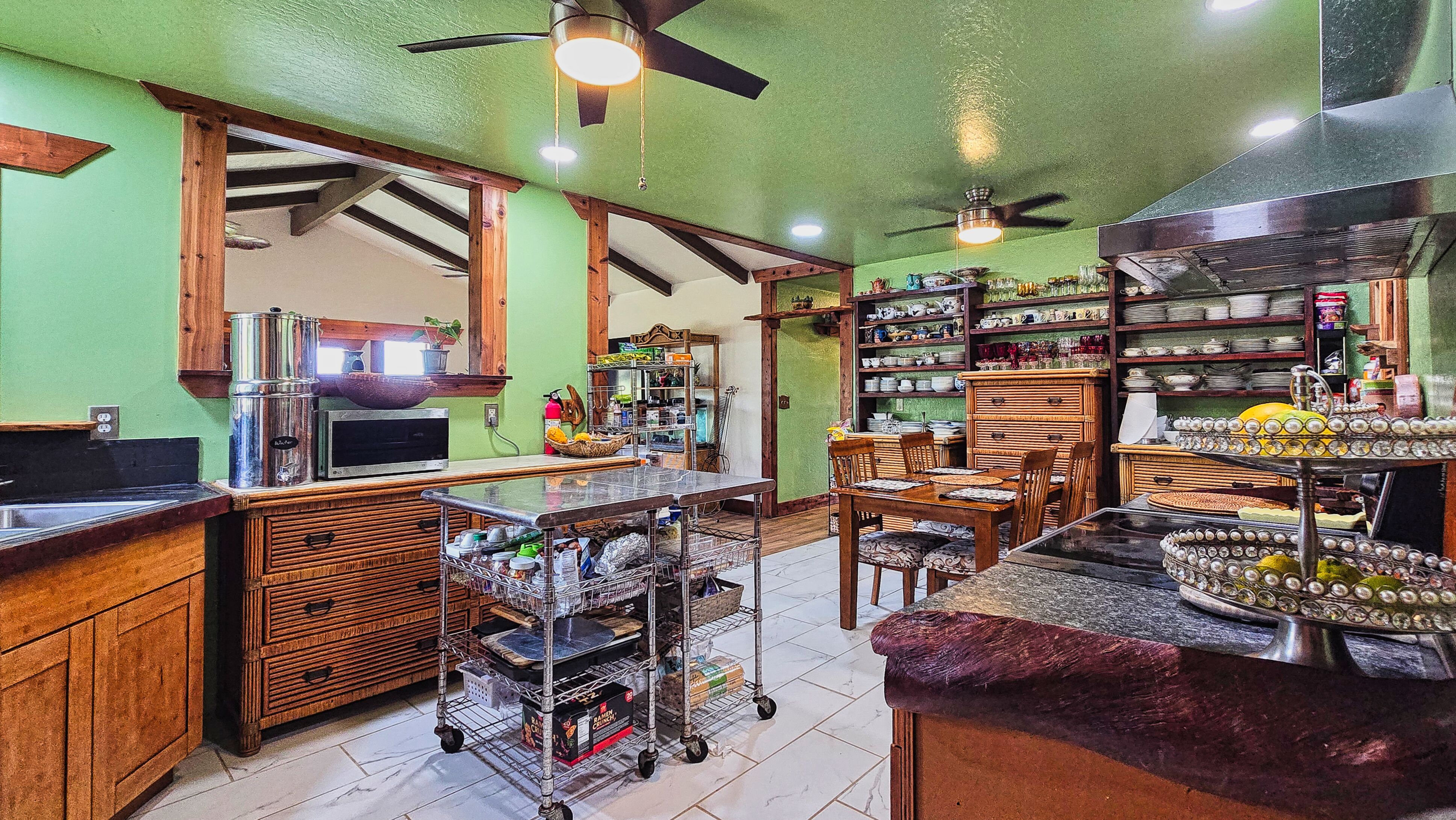 94-6491 Kamaoa Road Naalehu, HI 96772 - Photo 7 of 30 a view of a chairs and tables in a room