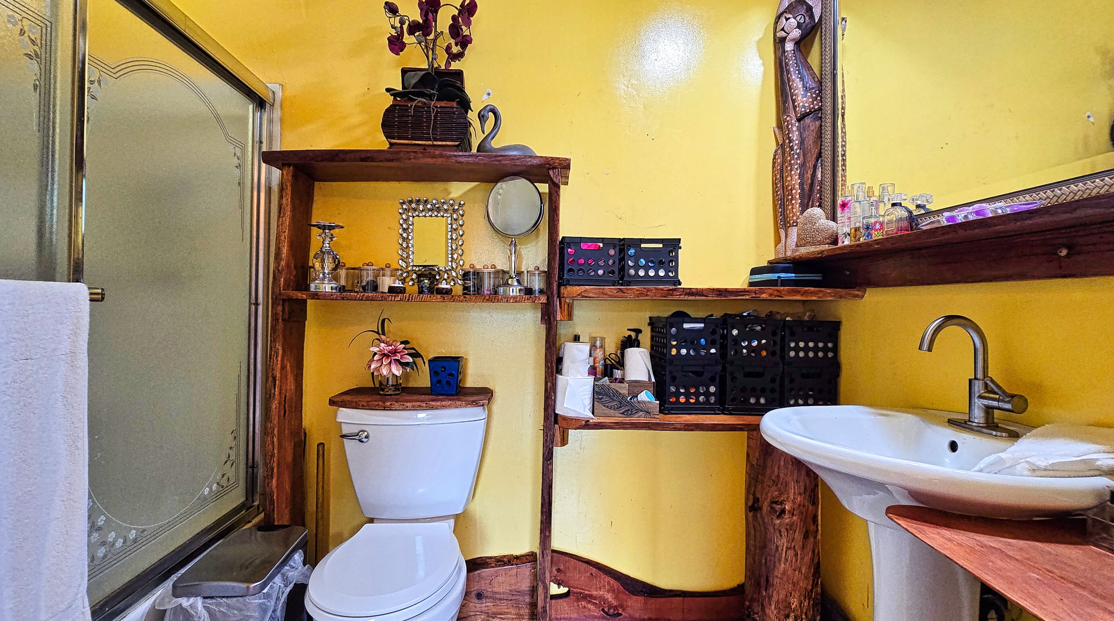 94-6491 Kamaoa Road Naalehu, HI 96772 - Photo 10 of 30 a bathroom with a sink mirror and toilet