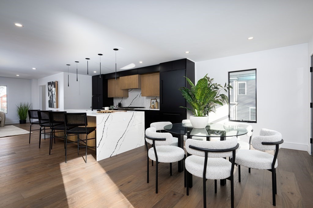 14 Edith Street, Unit 14 Arlington, MA 02474 - Photo 12 of 42 a living room with furniture a dining table and a potted plant