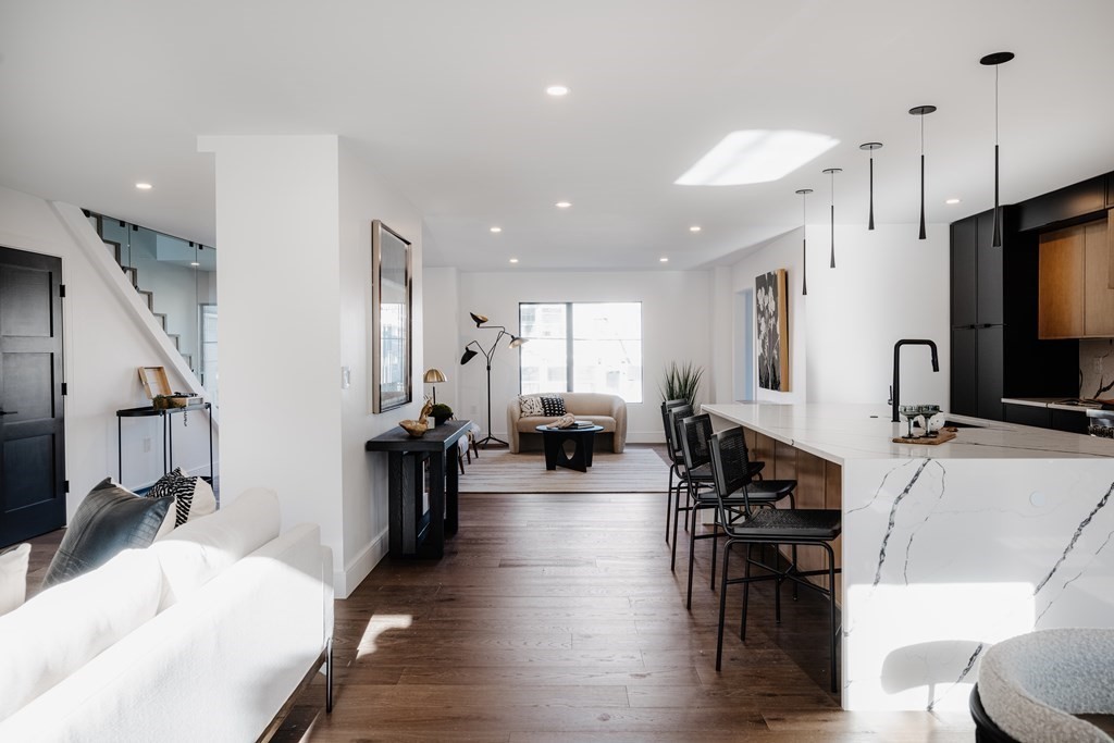 14 Edith Street, Unit 14 Arlington, MA 02474 - Photo 20 of 42 a living room with furniture a dining table and chairs with wooden floor