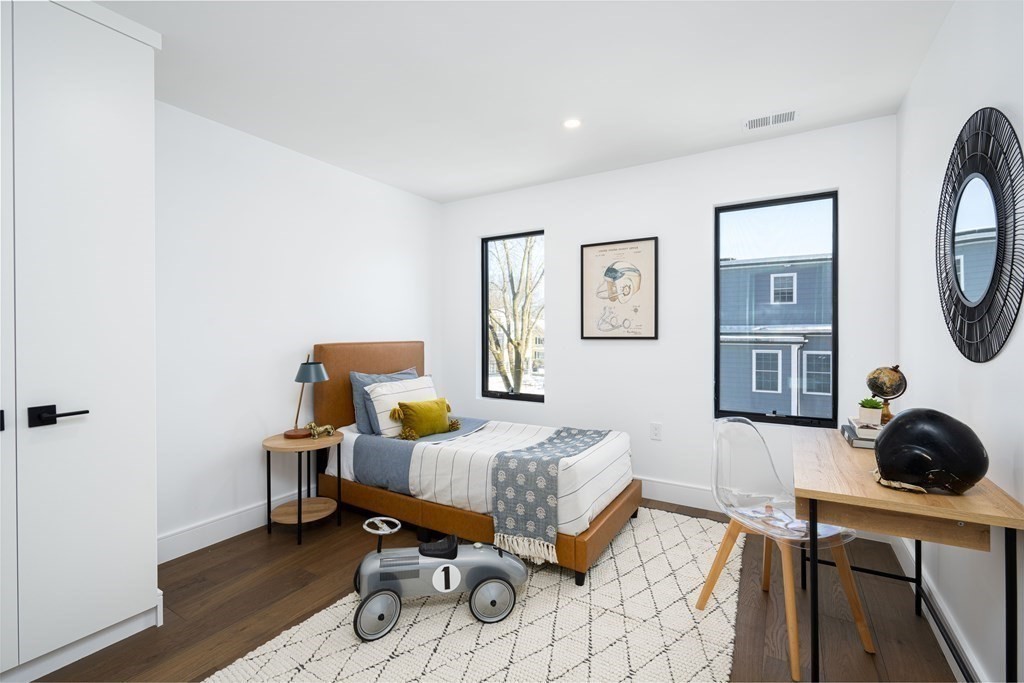 14 Edith Street, Unit 14 Arlington, MA 02474 - Photo 22 of 42 a bedroom with furniture and a mirror