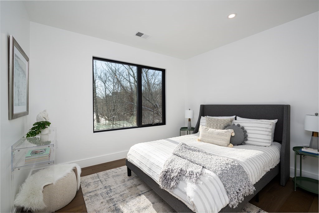 14 Edith Street, Unit 14 Arlington, MA 02474 - Photo 24 of 42 a bedroom with a bed and wooden floor