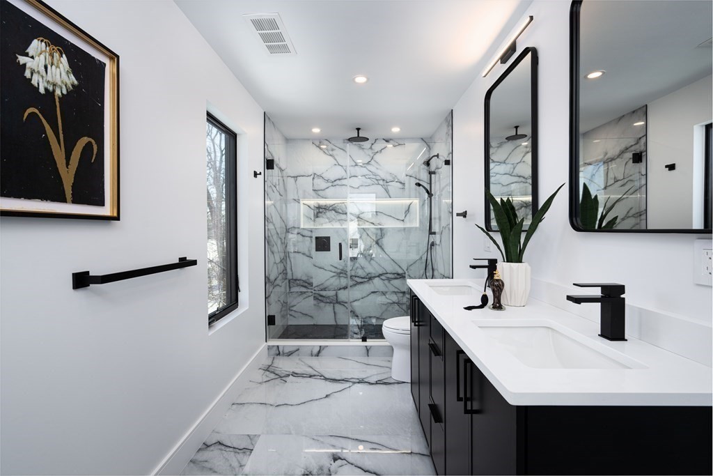 14 Edith Street, Unit 14 Arlington, MA 02474 - Photo 33 of 42 a bathroom with a double vanity sink mirror and shower