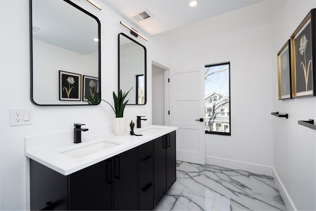 14 Edith Street, Unit 14 Arlington, MA 02474 - Photo 34 of 42 a bathroom with double sink and two mirror