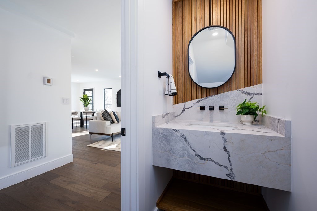 14 Edith Street, Unit 14 Arlington, MA 02474 - Photo 35 of 42 a living room with furniture and a mirror