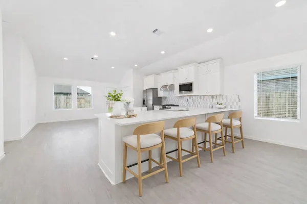 a kitchen with a table and chairs in it