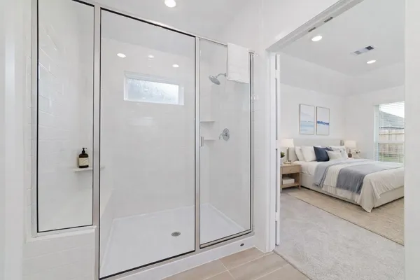 a spacious bedroom with a bed and a walk in closet