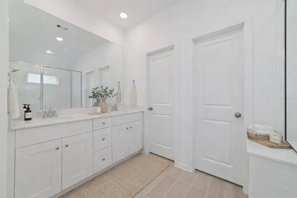 a bathroom with a double vanity sink and mirror