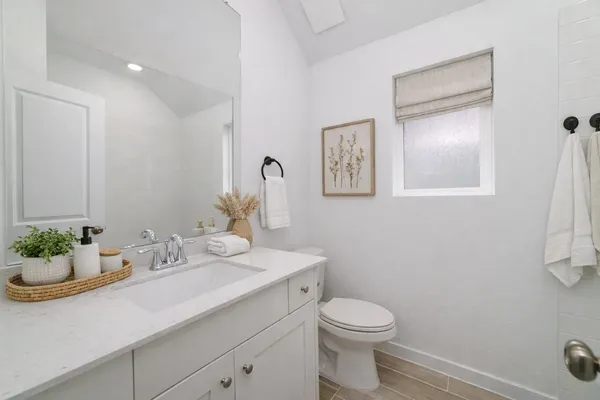 a bathroom with a sink a toilet and mirror