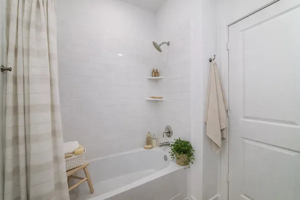 a bathroom with a bathtub and shower