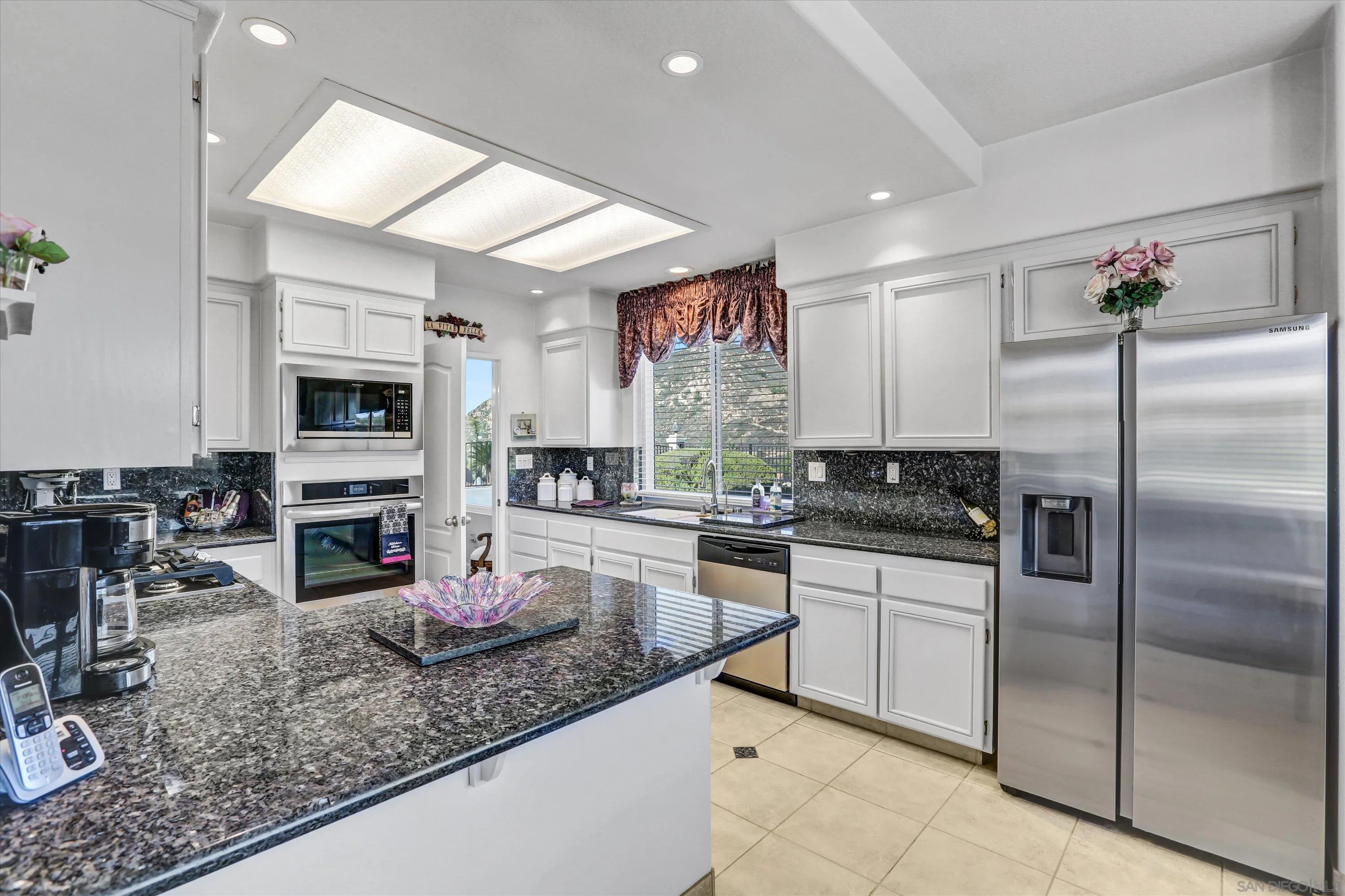 8983 Chestnut Roan Way Alpine, CA 91901 - Photo 12 of 33 a kitchen with stainless steel appliances granite countertop a sink stove and refrigerator