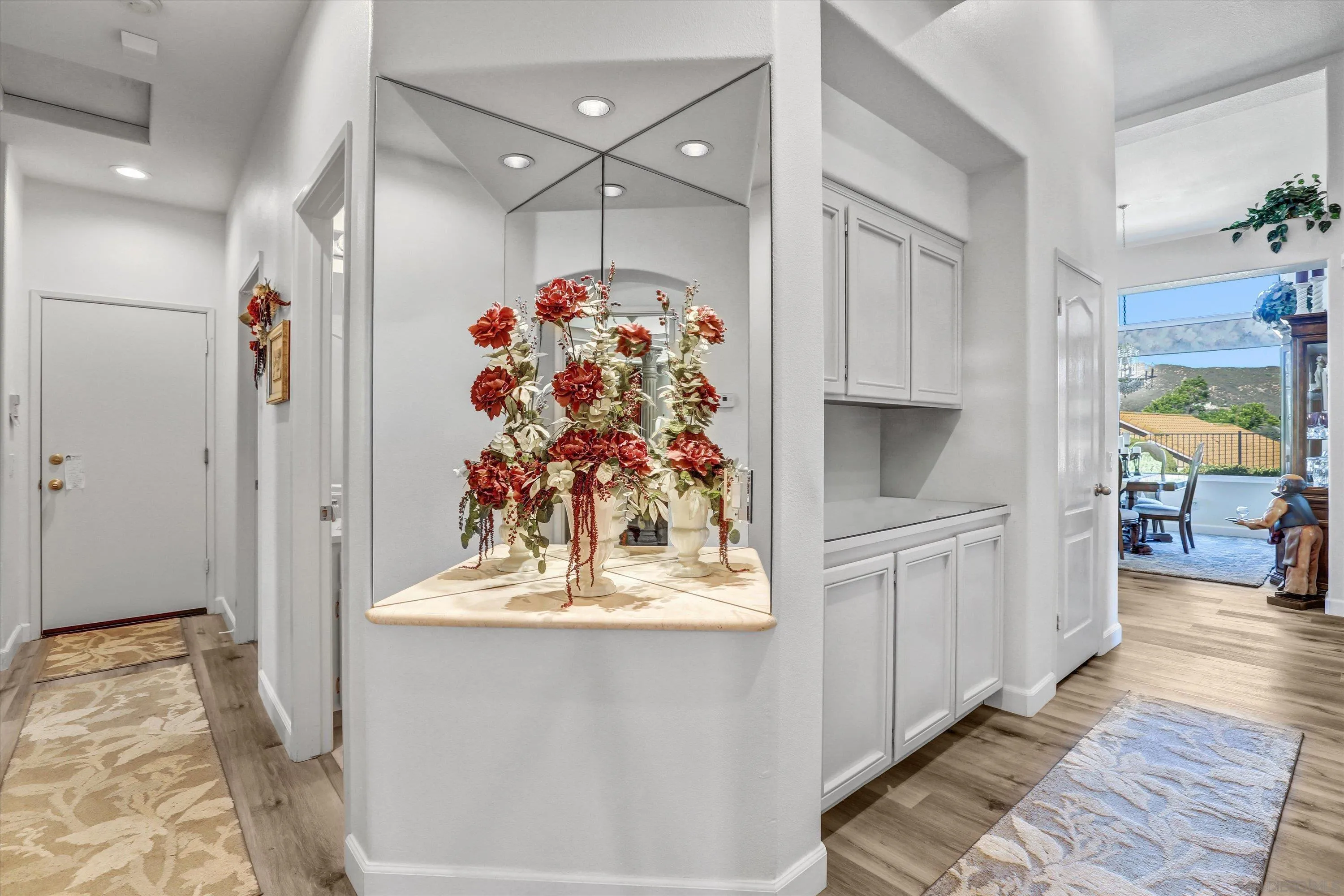 8983 Chestnut Roan Way Alpine, CA 91901 - Photo 18 of 33 a view of a hallway to a livingroom with wooden floor and chandelier