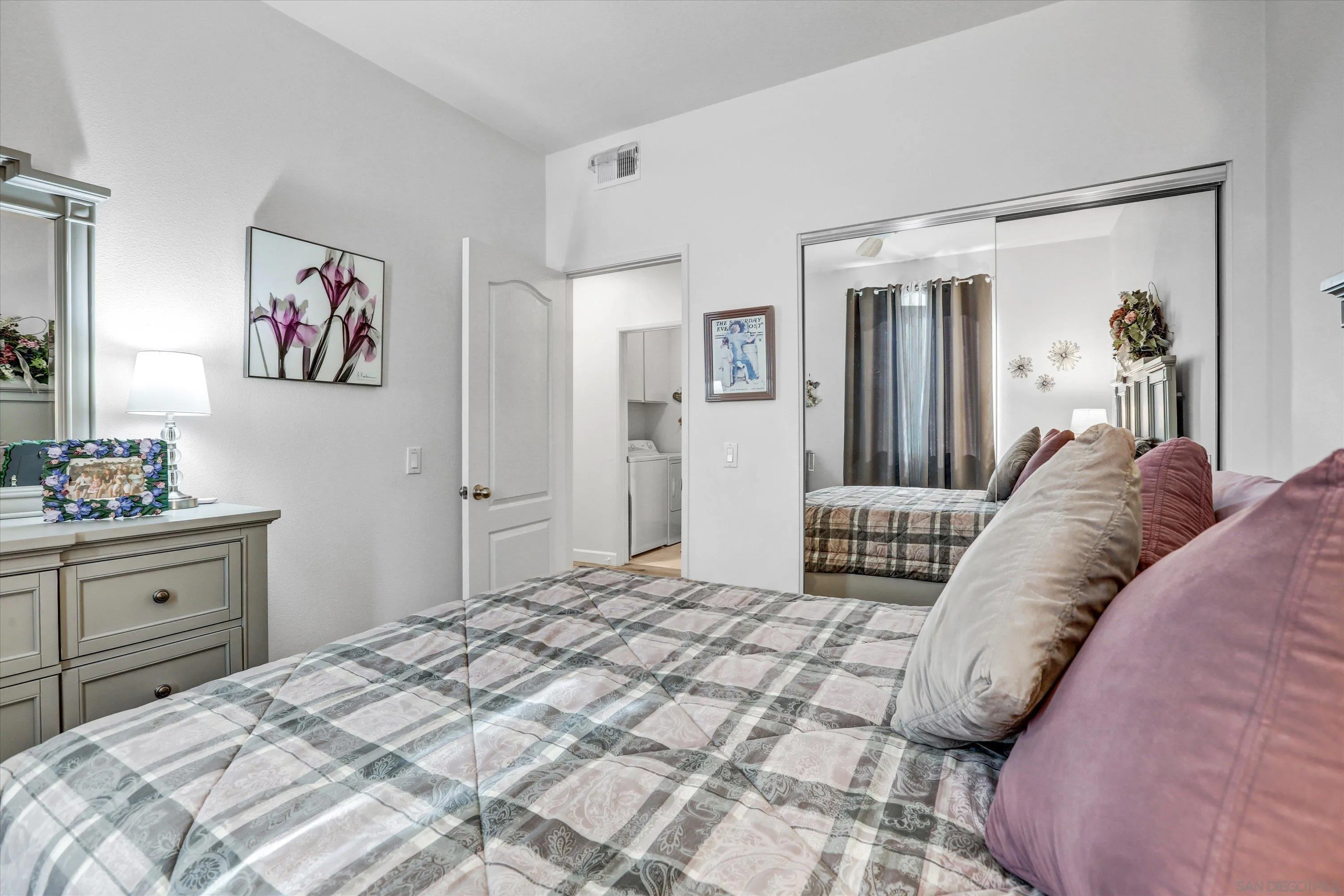 8983 Chestnut Roan Way Alpine, CA 91901 - Photo 23 of 33 a bedroom with a large bed and a chandelier