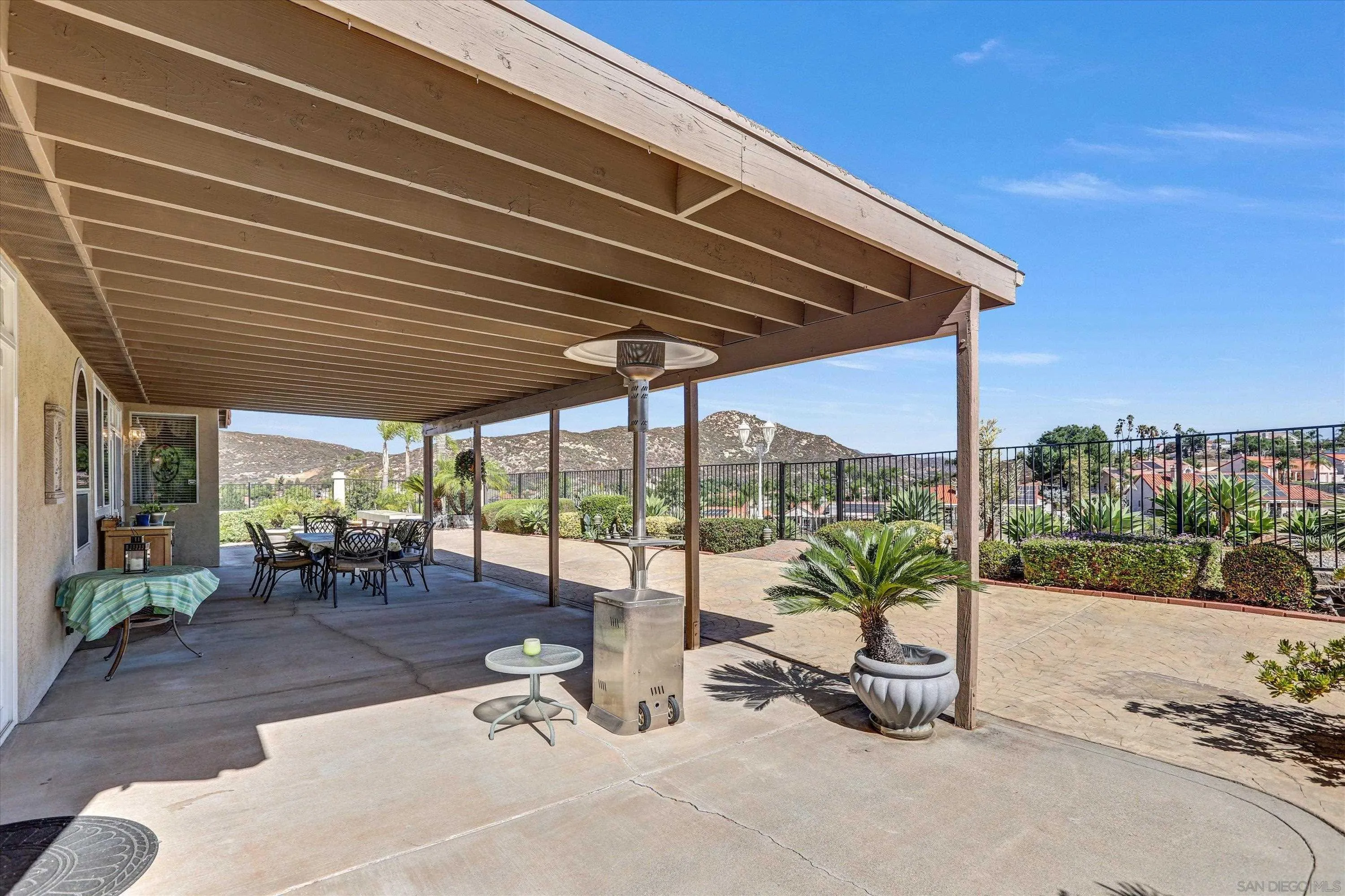 8983 Chestnut Roan Way Alpine, CA 91901 - Photo 32 of 33 a view of a patio with a table and chairs under an umbrella with a patio