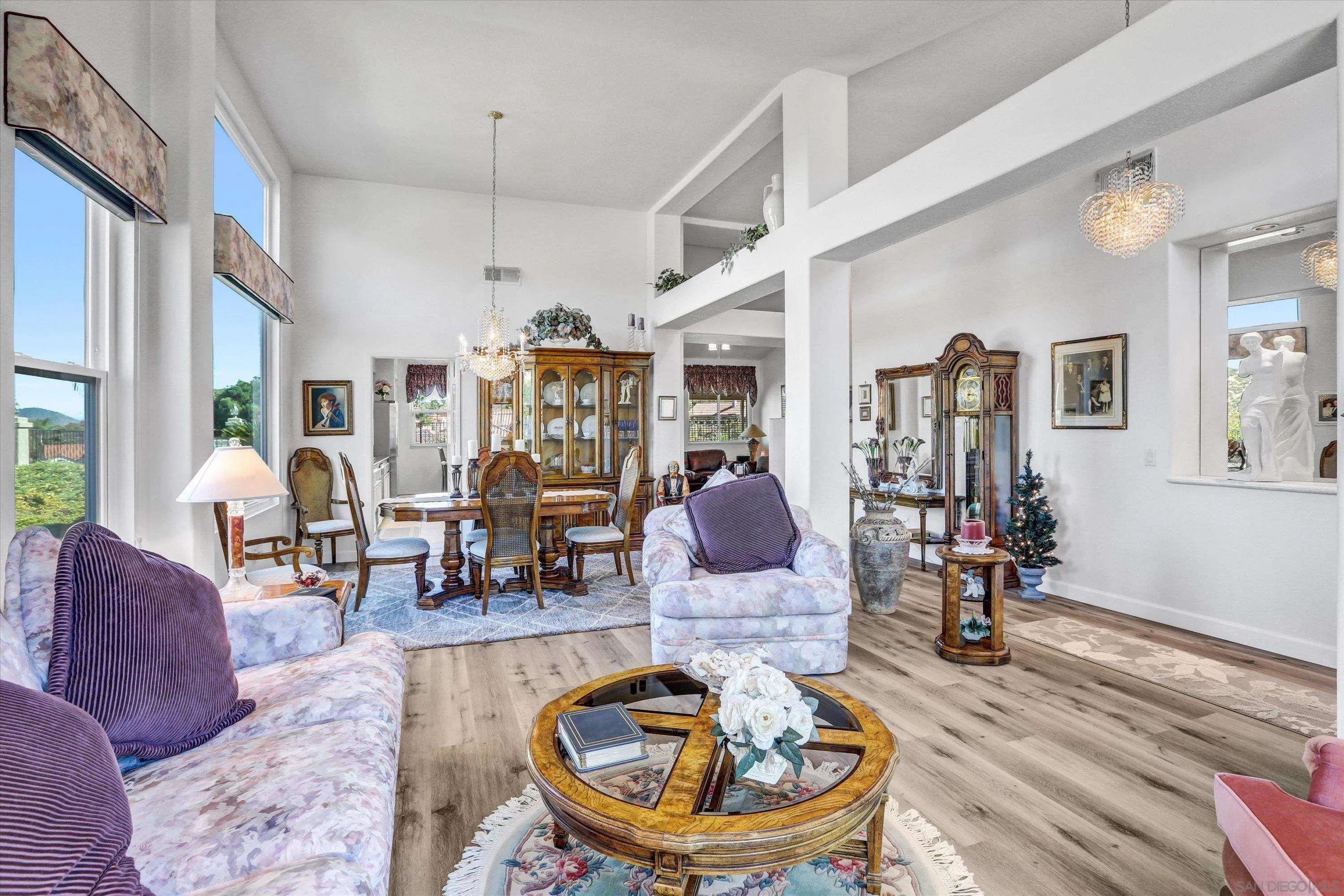 8983 Chestnut Roan Way Alpine, CA 91901 - Photo 6 of 33 a living room with furniture a dining table and a chandelier