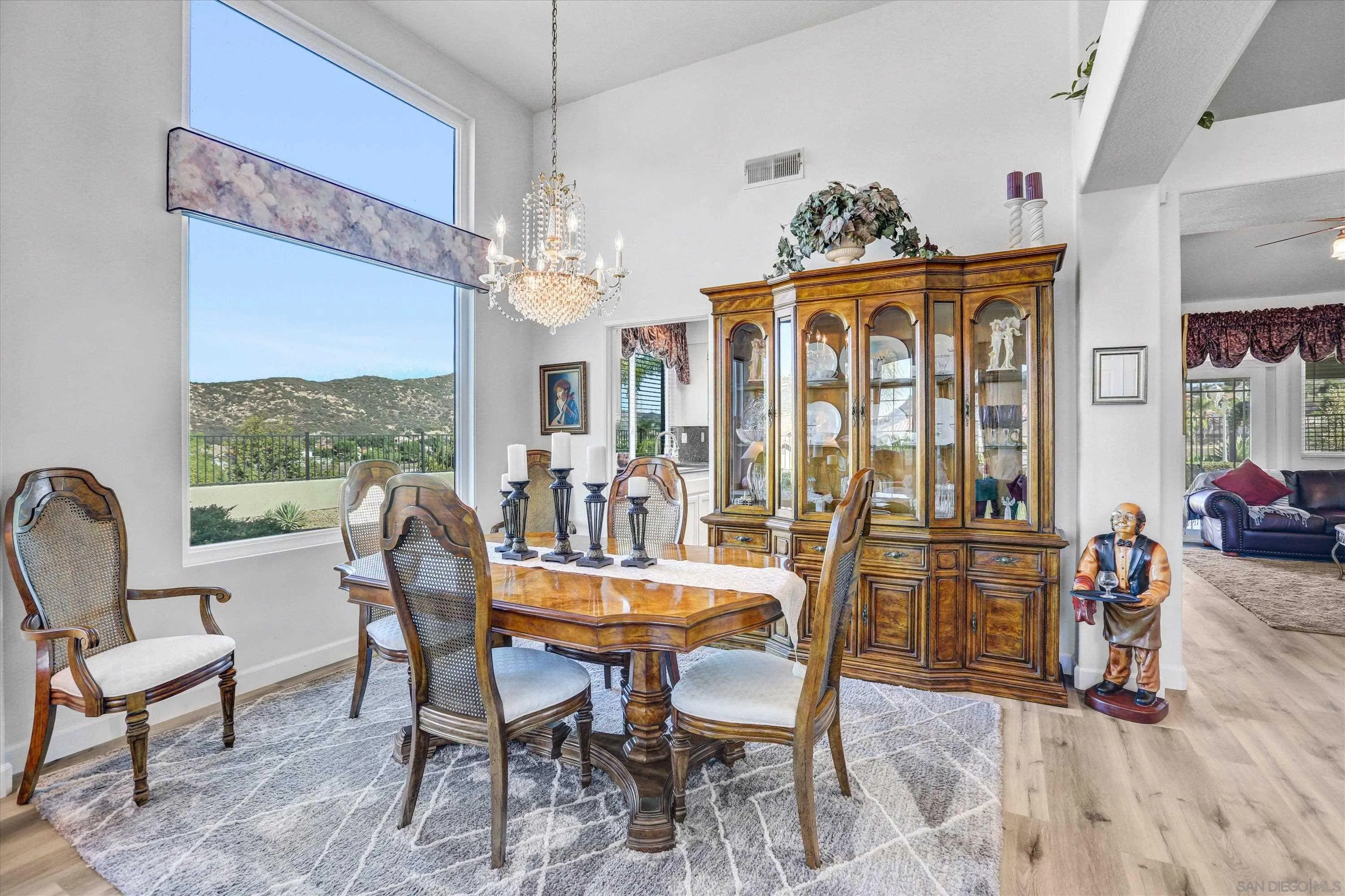 8983 Chestnut Roan Way Alpine, CA 91901 - Photo 8 of 33 a dining room with furniture a chandelier and wooden floor