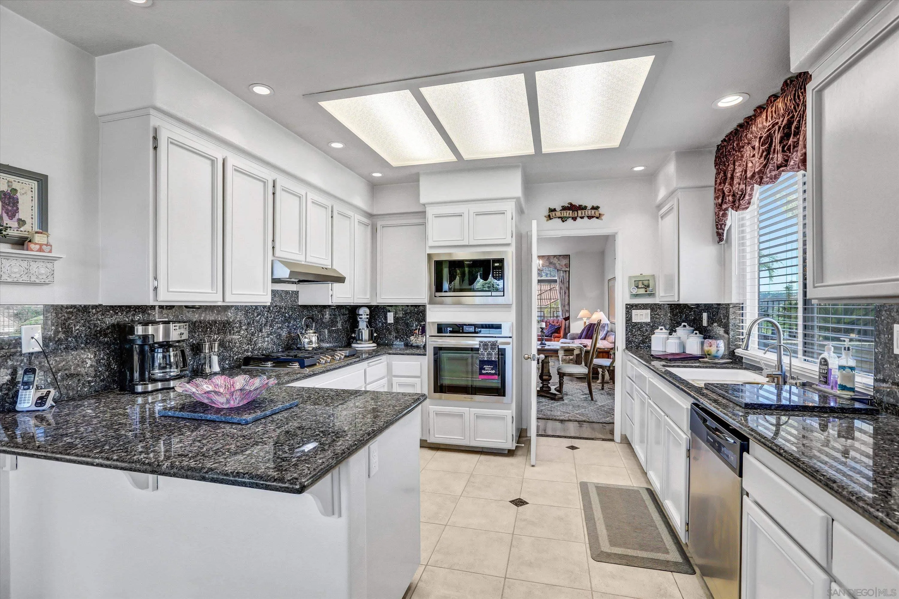 8983 Chestnut Roan Way Alpine, CA 91901 - Photo 10 of 33 a kitchen with stainless steel appliances granite countertop a sink counter space cabinets and a counter top space