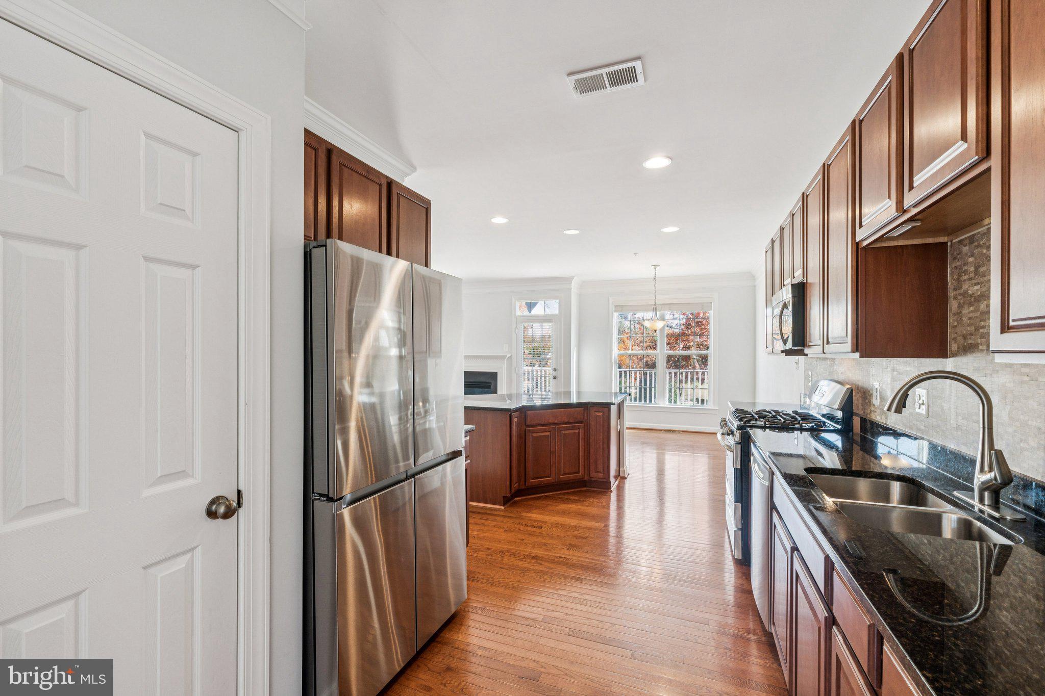 125 Autumn View Drive Gaithersburg, MD 20878 - Photo 11 of 38 a kitchen with stainless steel appliances granite countertop a refrigerator a sink a stove and cabinets