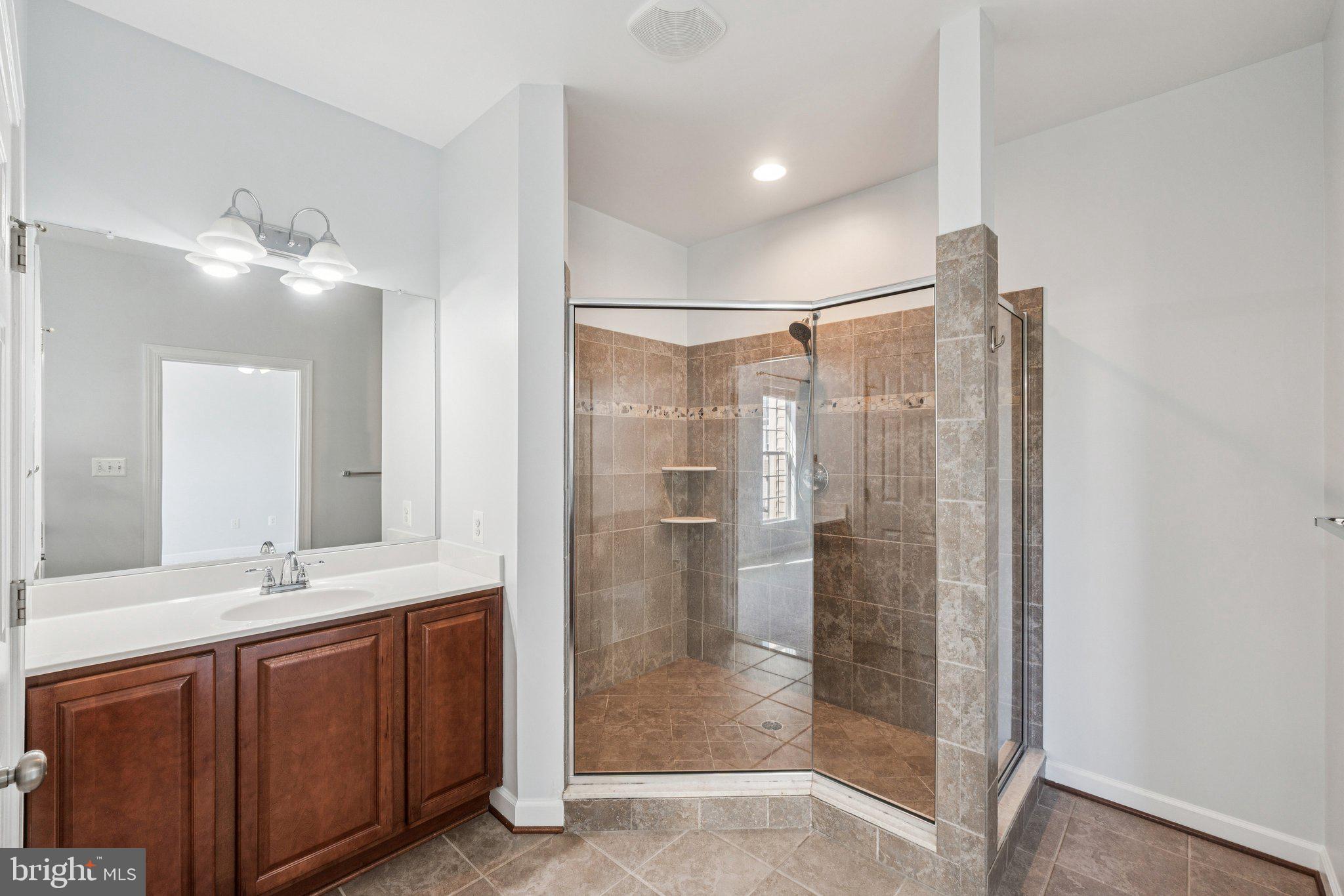 125 Autumn View Drive Gaithersburg, MD 20878 - Photo 23 of 38 a bathroom with a shower sink and mirror