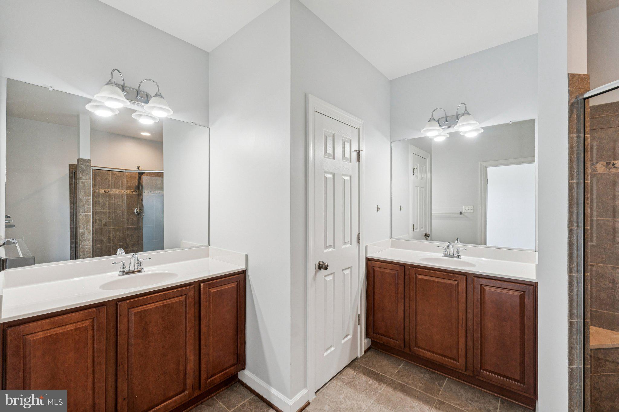125 Autumn View Drive Gaithersburg, MD 20878 - Photo 24 of 38 a bathroom with double vanity sinks and a mirror