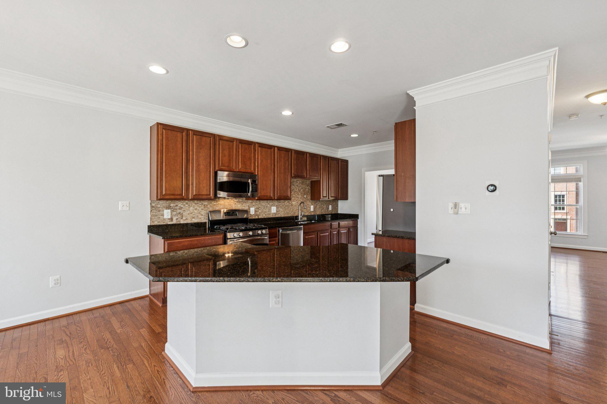 125 Autumn View Drive Gaithersburg, MD 20878 - Photo 4 of 38 a kitchen with stainless steel appliances granite countertop a refrigerator a sink a stove and a wooden floors