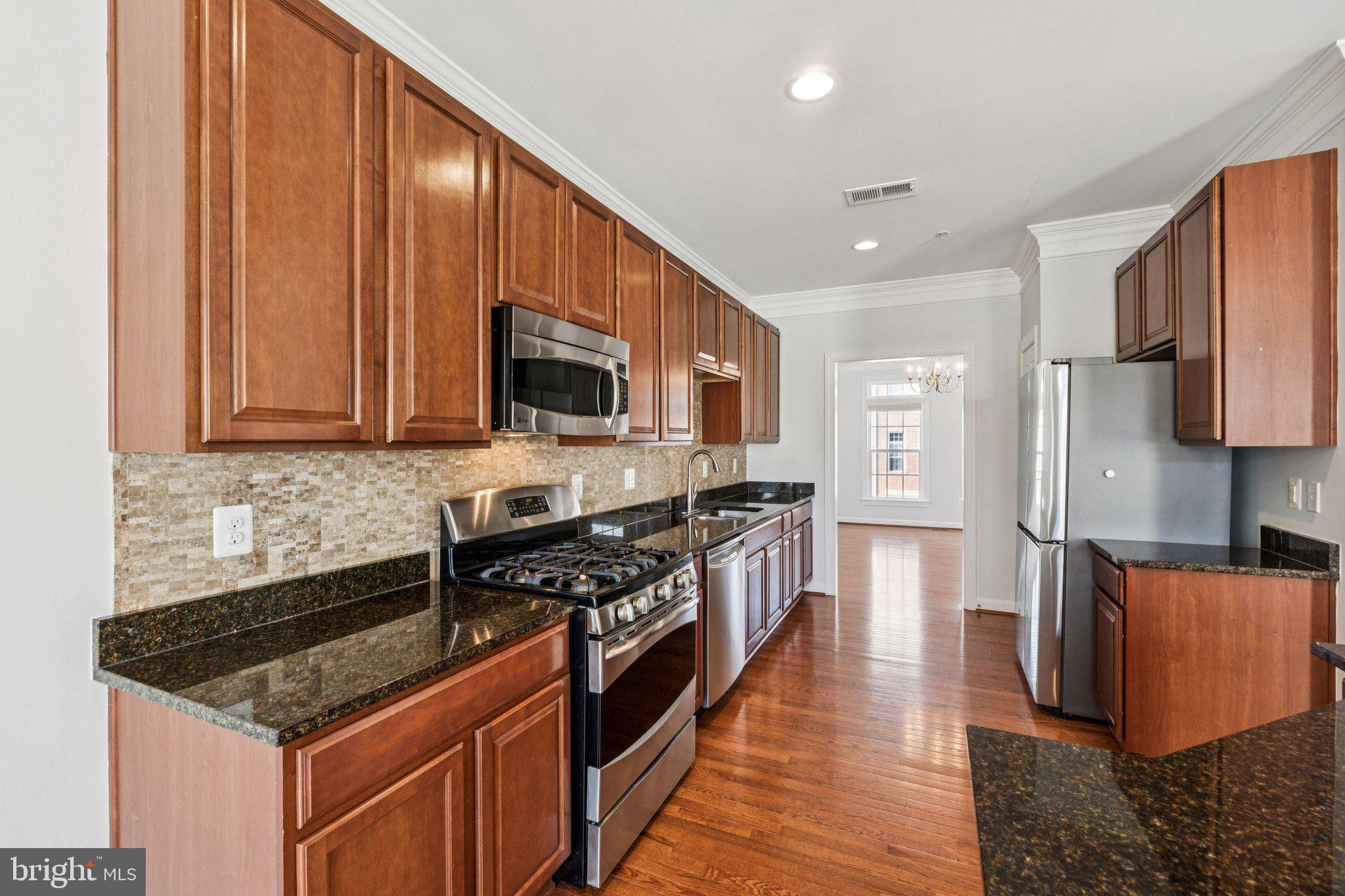 125 Autumn View Drive Gaithersburg, MD 20878 - Photo 10 of 38 a kitchen with stainless steel appliances granite countertop a stove a sink and a refrigerator