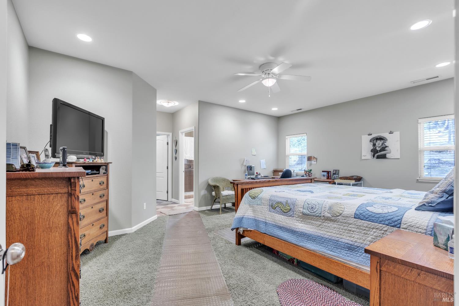 16911 Spruce Grove Road Hidden Valley Lake, CA 95467 - Photo 17 of 39 a bedroom with a bed and a flat screen tv