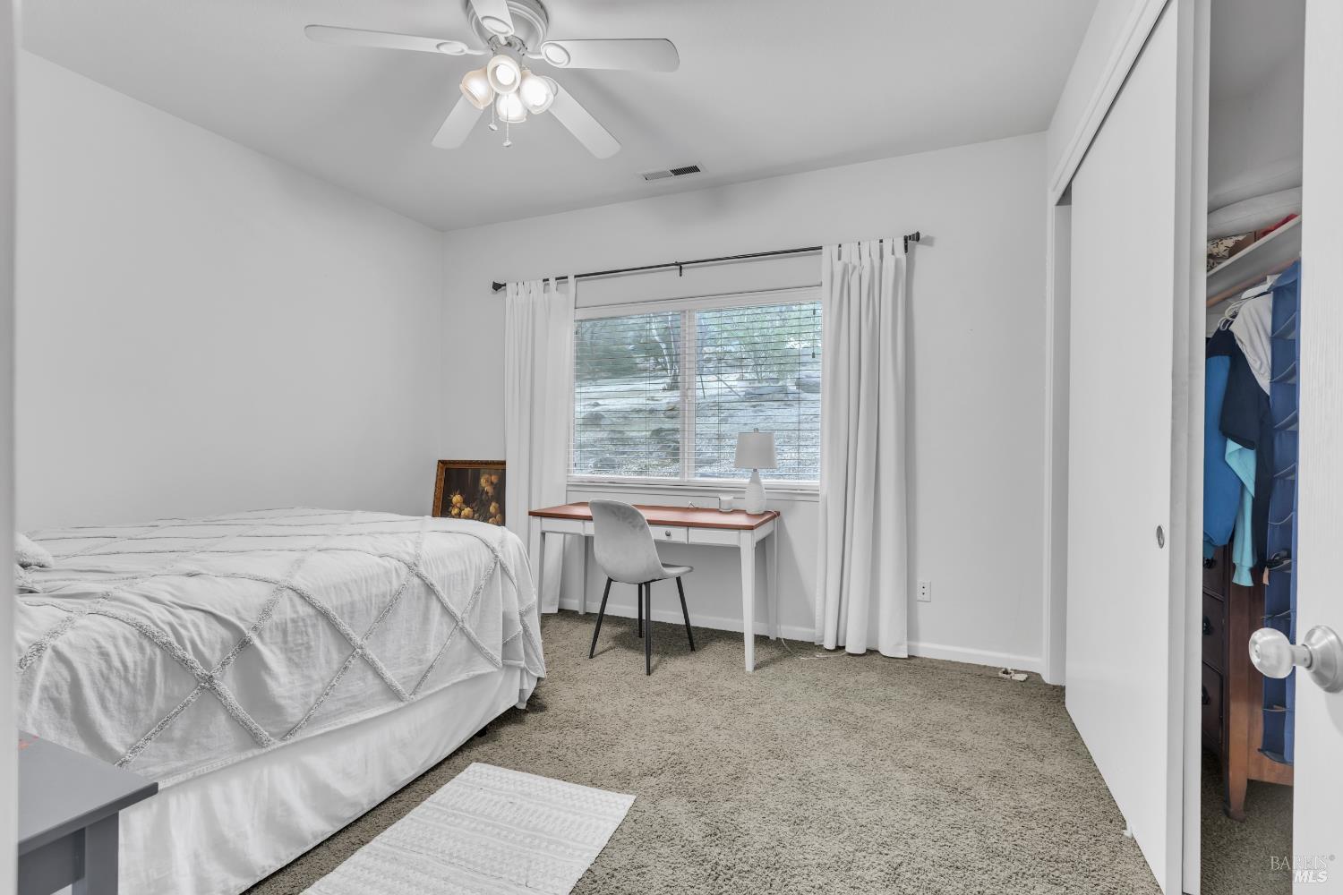 16911 Spruce Grove Road Hidden Valley Lake, CA 95467 - Photo 22 of 39 a bedroom with a bed and a chandelier
