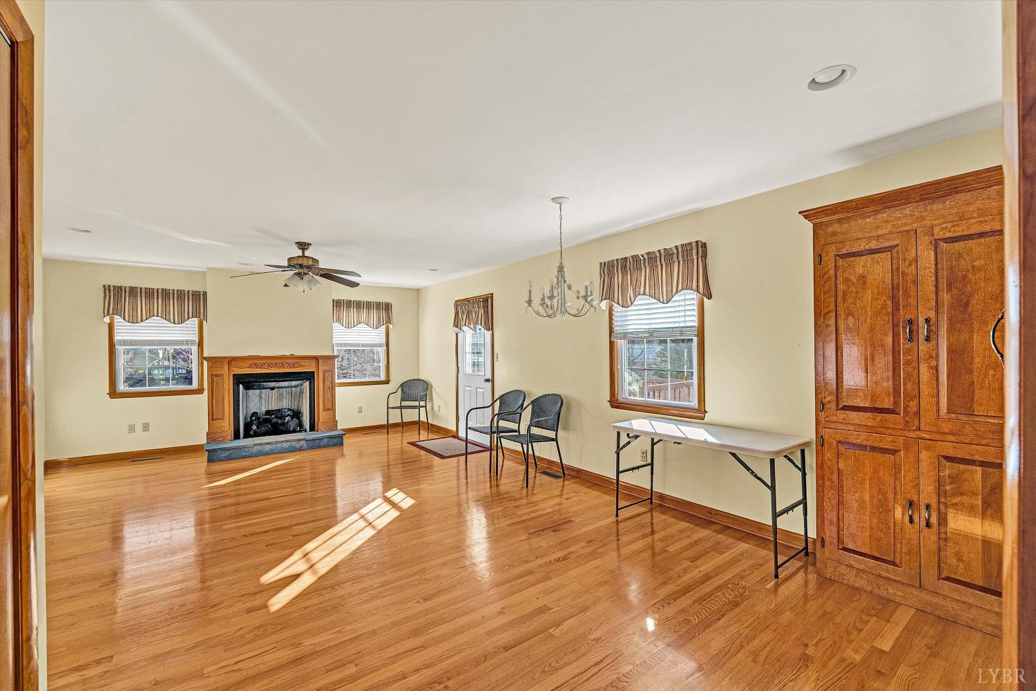 1524 Liggates Road Lynchburg, VA 24502 - Photo 10 of 31 a living room with furniture a fireplace and wooden floor