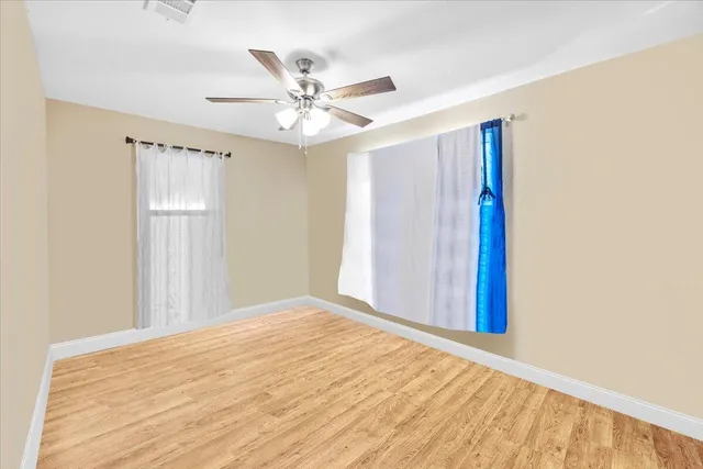 a view of a big room with wooden floor and closet in a room