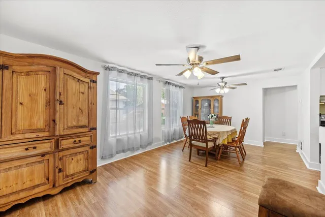 a view of a dining room with furniture window and wooden floor
