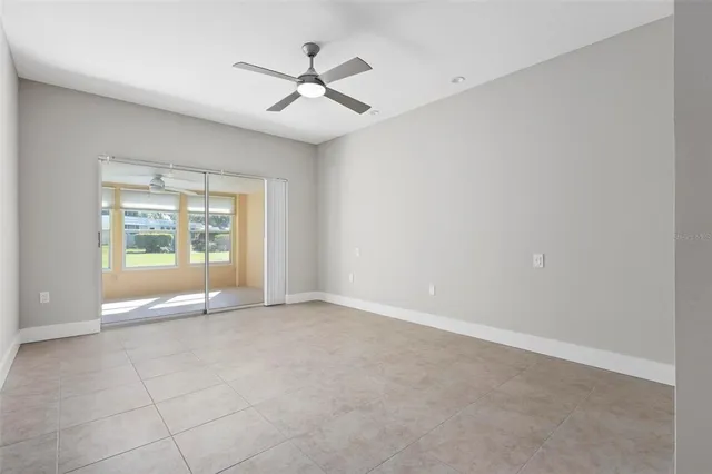 an empty room with a ceiling fan and a ceiling fan