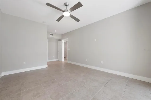 a bathroom with a granite countertop sink toilet a mirror and shower