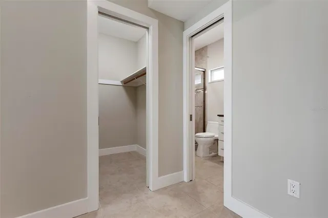 an empty room with a ceiling fan and carpet