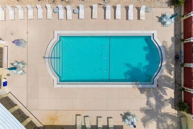 a view of a house with pool and chairs