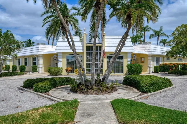 a view of a swimming pool with a yard and plants