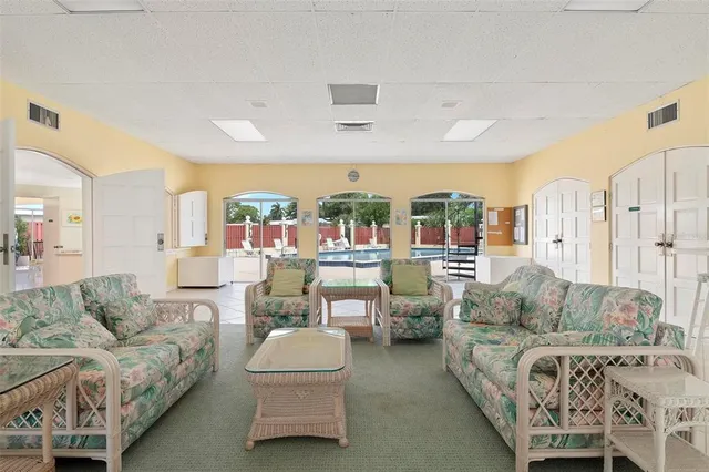 an aerial view of residential houses with outdoor space and lake view